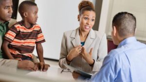 parents sitting with child talking to counselor