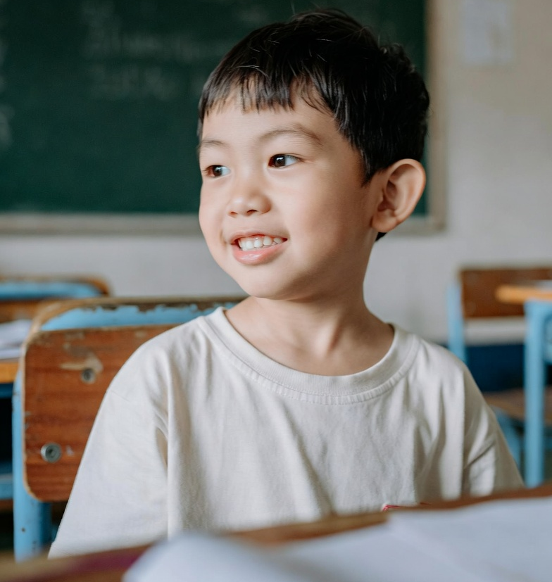 Child Smiles in Classroom